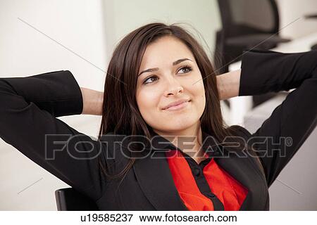 Stock Photo - Businesswoman relaxing at desk. Fotosearch