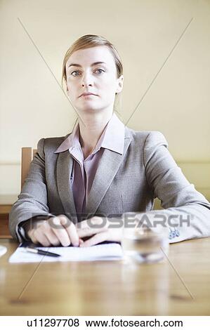 Stock Photo - Businesswoman sitting in cafe. Fotosearch