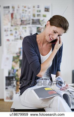 Stock Photo - Businesswoman talking on cell phone. Fotosearch