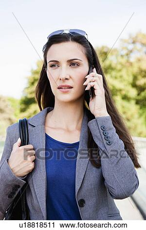 Businesswoman using cell phone outdoors View Large Photo Image Stock Image - Businesswoman using cell phone outdoors. Fotosearch