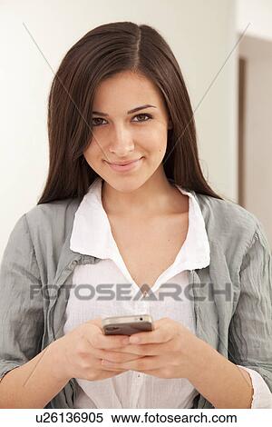 Stock Photography - Businesswoman using cell phone. Fotosearch