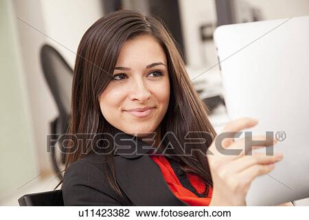 Stock Image - Businesswoman using tablet computer. Fotosearch