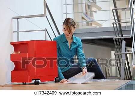 Businesswoman working on floor in office View Large Photo Image Stock Photo - Businesswoman working on floor in office. Fotosearch