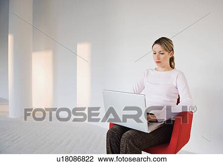 Stock Image - Businesswoman working on laptop. Fotosearch