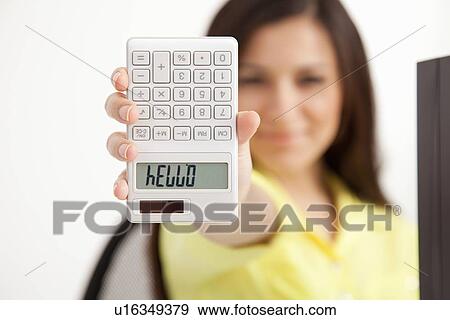 Stock Photo - Businesswoman writing on calculator. Fotosearch