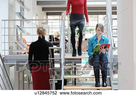 Businesswomen on steps in office View Large Photo Image Stock Image - Businesswomen on steps in office. Fotosearch