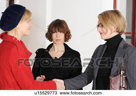 Stock Image - Businesswomen talking in office. Fotosearch