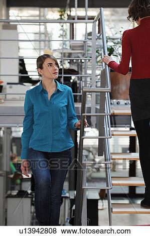 Stock Photo - Businesswomen walking in office. Fotosearch