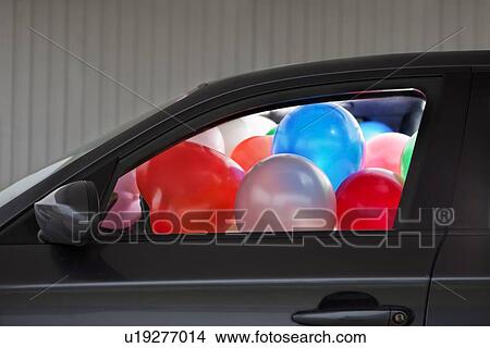 Picture - Car filled with colorful balloons. Fotosearch