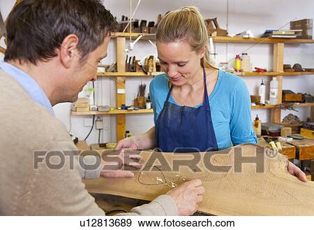 Carpenter and assistant working in shop View Large Photo Image Stock Photo - Carpenter and assistant working in shop. Fotosearch
