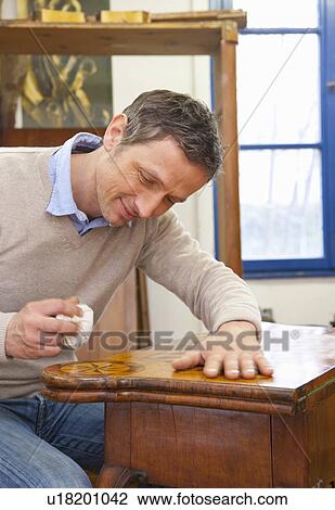 Carpenter buffing wooden table View Large Photo Image Stock Image - Carpenter buffing wooden table. Fotosearch