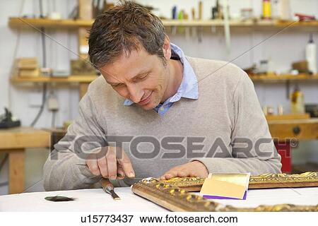 Stock Photo - Carpenter working in shop. Fotosearch