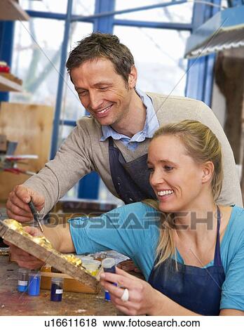 Carpenter working with assistant in shop View Large Photo Image Stock Photo - Carpenter working with assistant in shop. Fotosearch