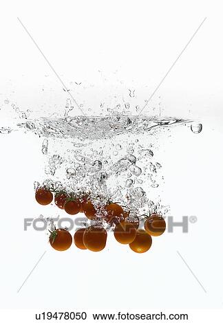 Cherry tomatoes splashing in water View Large Photo Image Stock Image - Cherry tomatoes splashing in water. Fotosearch