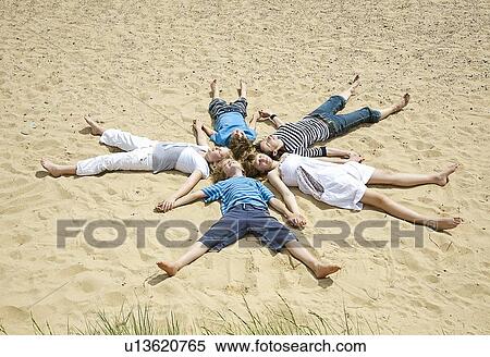 Children laying in formation on beach View Large Photo Image Stock Photography - Children laying in formation on beach. Fotosearch