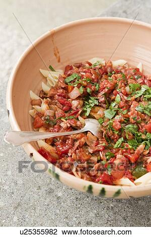Stock Image - Close up of bowl of pasta with sauce. Fotosearch