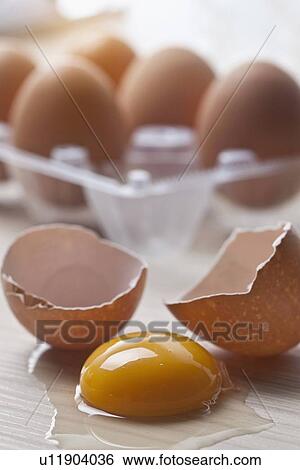 Stock Photograph - Close up of broken eggshells and yolk. Fotosearch