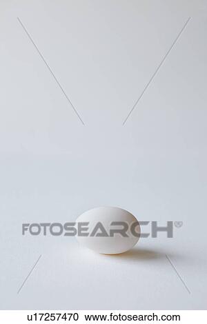 Stock Image - Close up of egg on countertop. Fotosearch