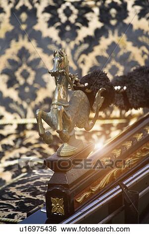 Stock Photograph - Close up of figurine on banister. Fotosearch