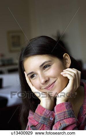 Close up of girl resting chin in hands View Large Photo Image Stock Photo - Close up of girl resting chin in hands. Fotosearch