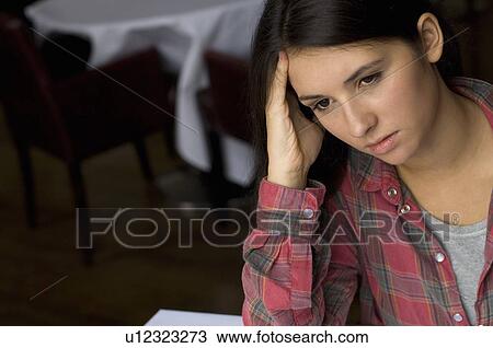 Close up of girl rubbing her forehead View Large Photo Image Stock Image - Close up of girl rubbing her forehead. Fotosearch