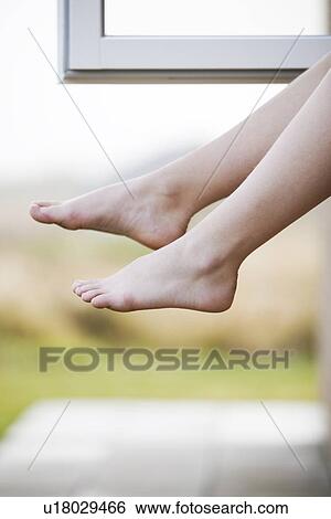 Close up of legs dangling outside window View Large Photo Image Stock Photograph - Close up of legs dangling outside window. Fotosearch