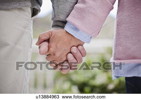 Close up of older couple holding hands View Large Photo Image Stock Image - Close up of older couple holding hands. Fotosearch