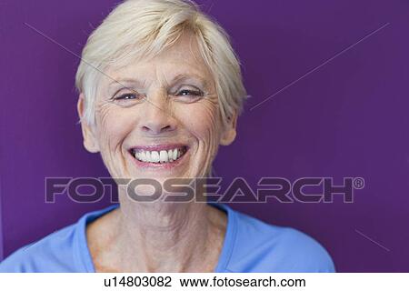 Stock Image - Close up of older womans smiling face. Fotosearch