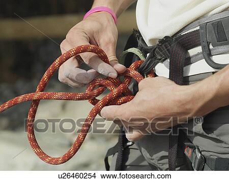 Close up of rock climber tying knot View Large Photo Image Picture - Close up of rock climber tying knot. Fotosearch