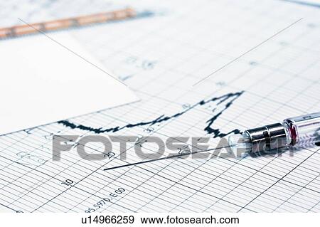 Stock Photo - Close up of syringe on graph in lab. Fotosearch