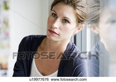 Close up of woman leaning on window View Large Photo Image Stock Photograph - Close up of woman leaning on window. Fotosearch