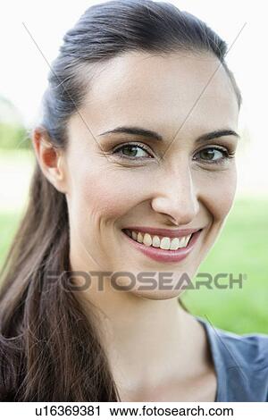 Stock Image - Close up of womans smiling face. Fotosearch