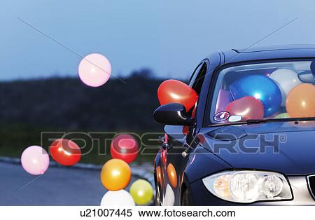 Stock Photography - Colorful balloons coming out car window. Fotosearch