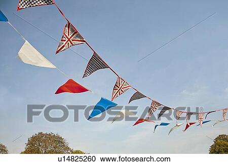 Stock Image - Colorful flags blowing in wind. Fotosearch