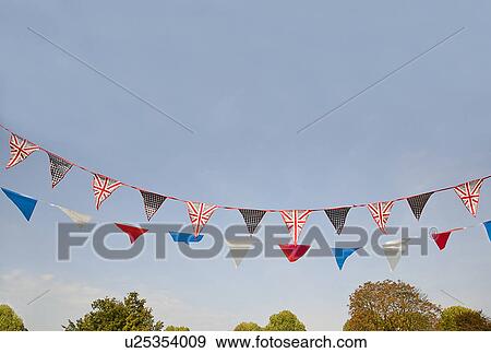 Colorful flags blowing in wind View Large Photo Image Stock Photo - Colorful flags blowing in wind. Fotosearch