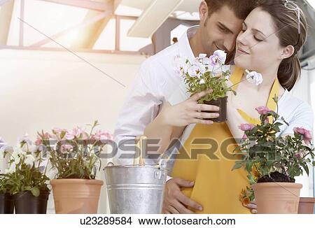 Couple de-potting plants together View Large Photo Image Picture - Couple de-potting plants together. Fotosearch