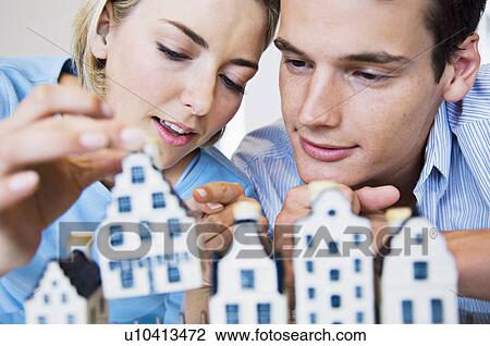Couple examining model houses View Large Photo Image Stock Image - Couple examining model houses. Fotosearch