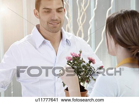 Couple holding potted flowers View Large Photo Image Stock Image - Couple holding potted flowers. Fotosearch