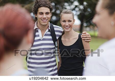 Couple hugging in park View Large Photo Image Stock Image - Couple hugging in park. Fotosearch