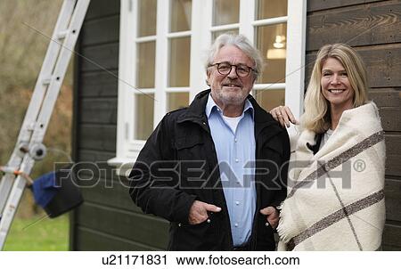 Stock Image - Couple standing outdoors together. Fotosearch