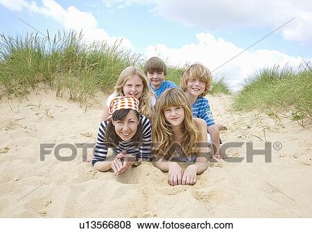 Family playing together on beach View Large Photo Image Stock Photo - Family playing together on beach. Fotosearch