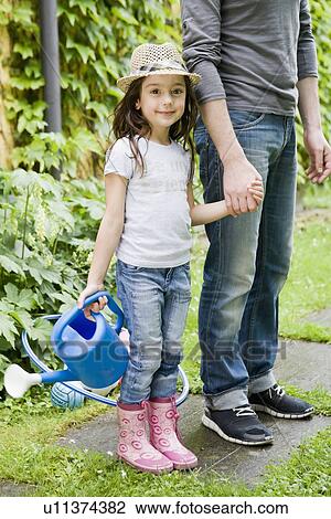 Father and daughter gardening together View Large Photo Image Stock Image - Father and daughter gardening together. Fotosearch