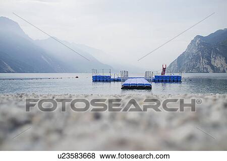 Floating pier off rocky beach View Large Photo Image Stock Photo - Floating pier off rocky beach. Fotosearch