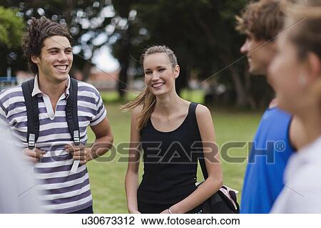 Friends talking in park View Large Photo Image Stock Image - Friends talking in park. Fotosearch