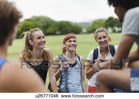 Friends talking in park View Large Photo Image Stock Photograph - Friends talking in park. Fotosearch