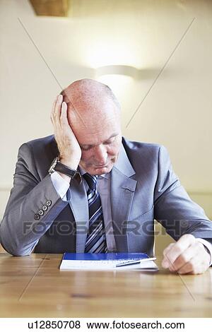 Frustrated businessman sitting in cafe View Large Photo Image Stock Photo - Frustrated businessman sitting in cafe. Fotosearch
