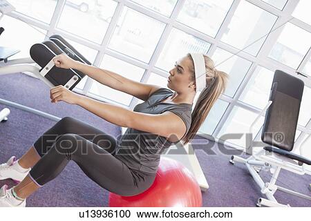 Girl exercising in gym View Large Photo Image Stock Image - Girl exercising in gym. Fotosearch