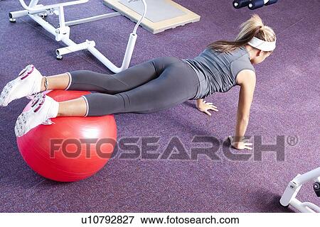 Girl exercising in gym View Large Photo Image Stock Photo - Girl exercising in gym. Fotosearch