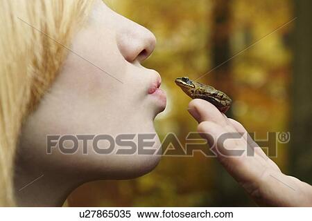 Girl kissing tiny frog in forest View Large Photo Image Stock Photography - Girl kissing tiny frog in forest. Fotosearch