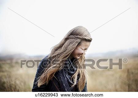 Girl laughing in wheatfield View Large Photo Image Stock Image - Girl laughing in wheatfield. Fotosearch